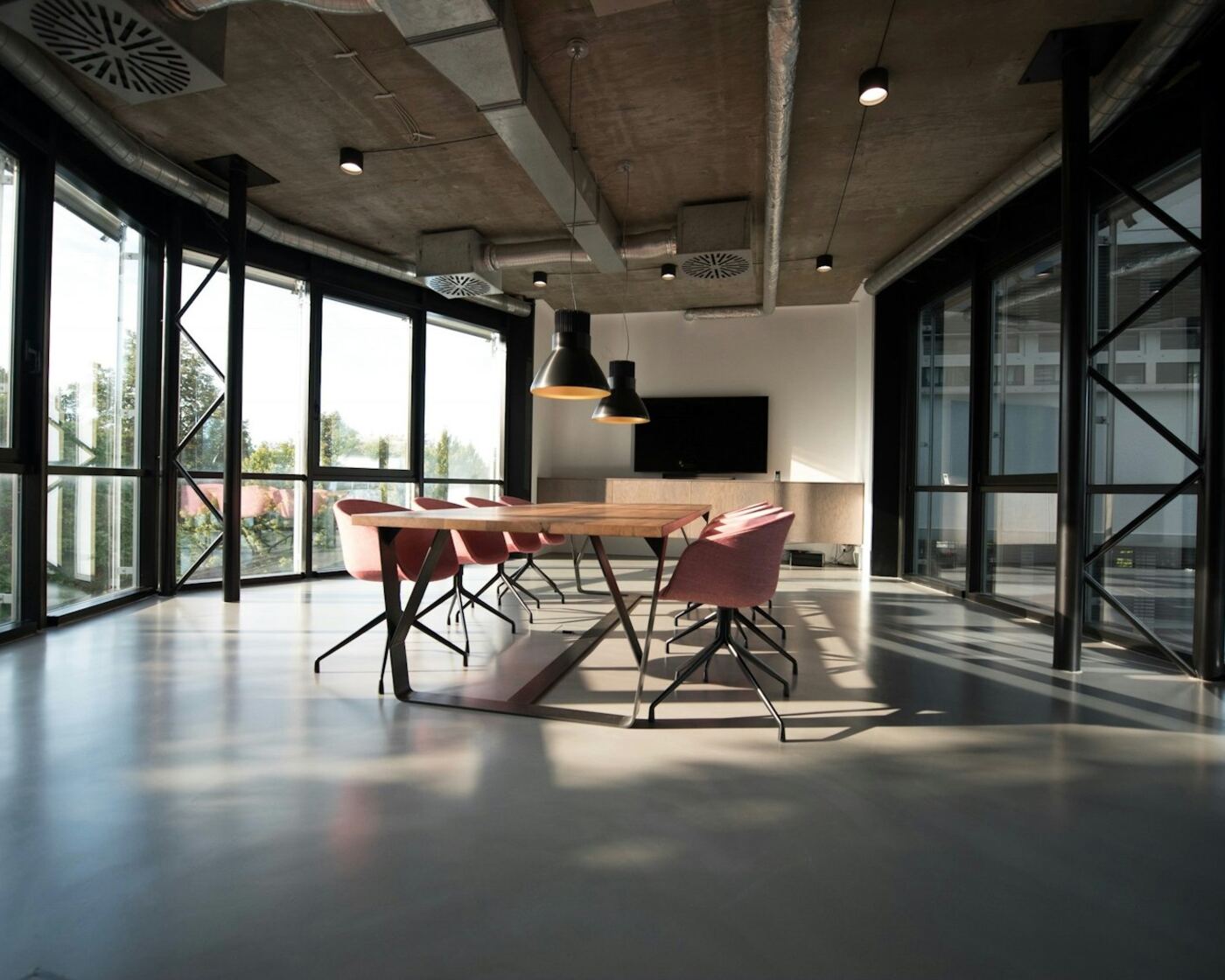 Modern agency conference room with glass walls and a long table