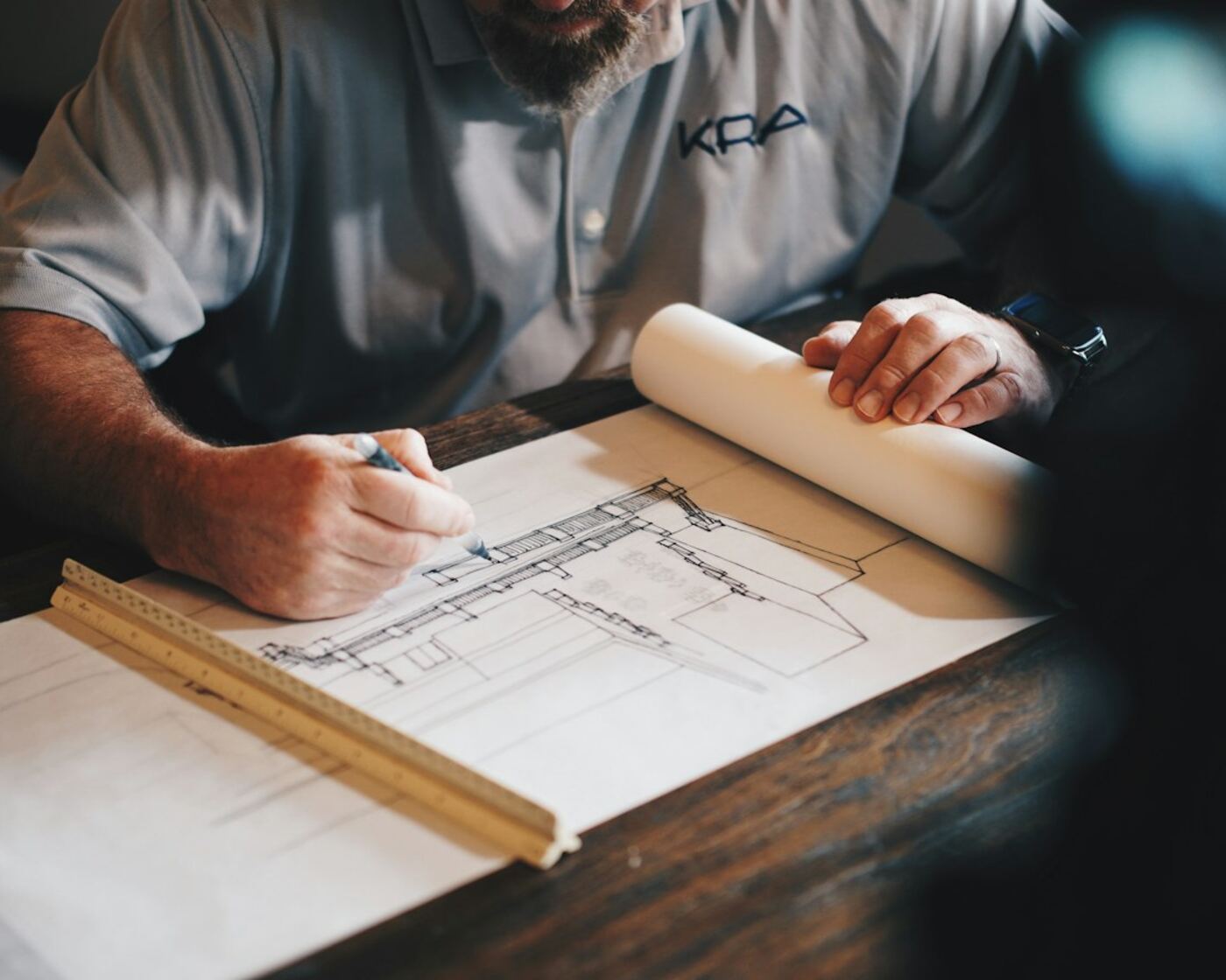 Architect reviewing building drawings at a drafting table