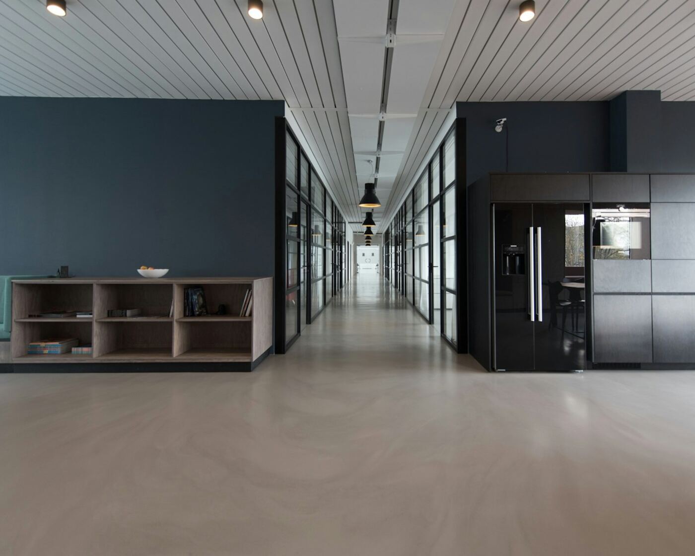 Quiet modern office interior with desks and glass walls