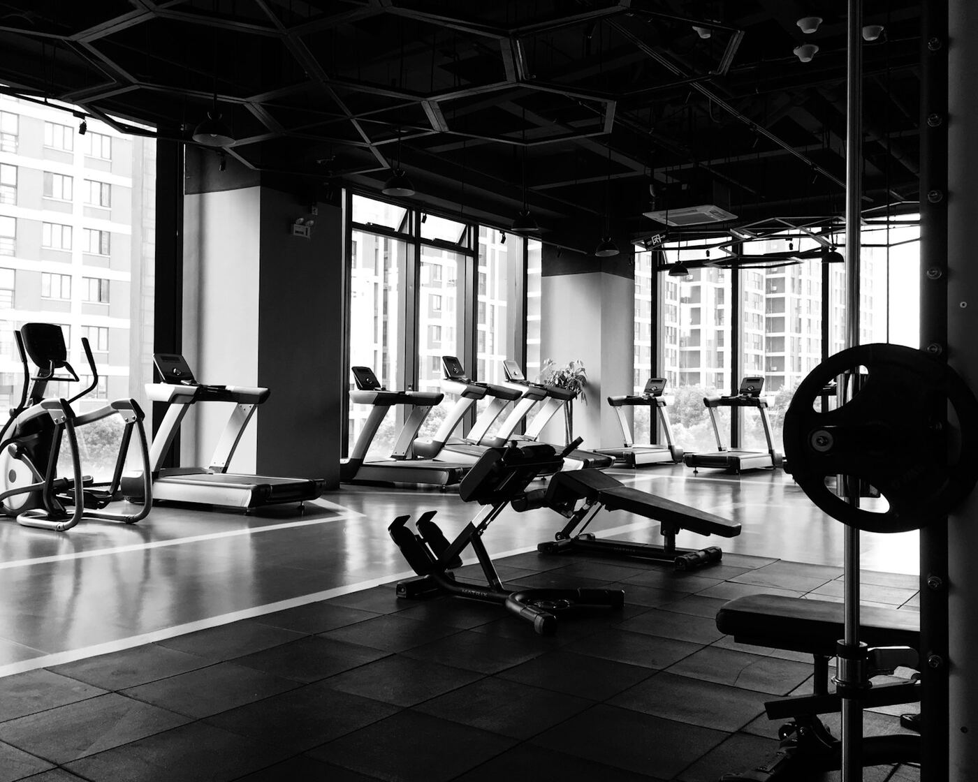 Empty gym floor with cardio machines and weight equipment