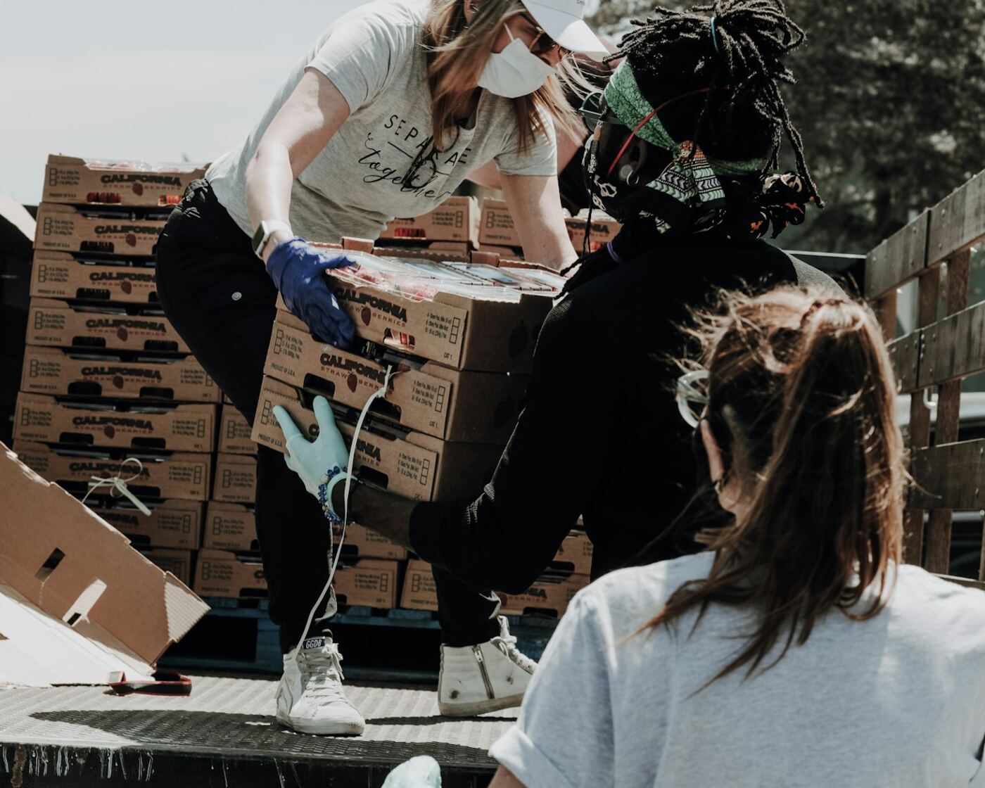 Volunteers unloading donated food boxes from a truck