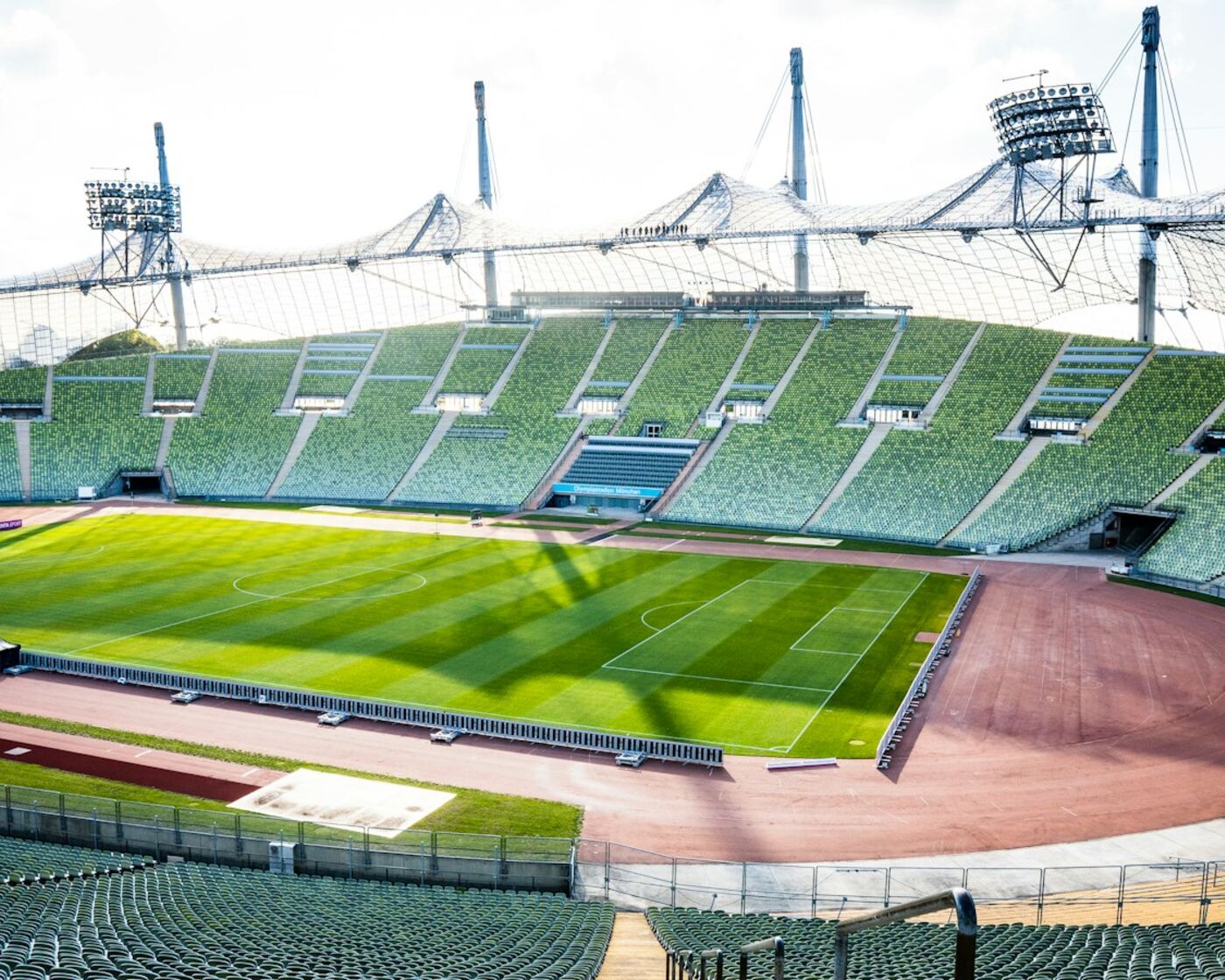Empty Olympic stadium with green field and track